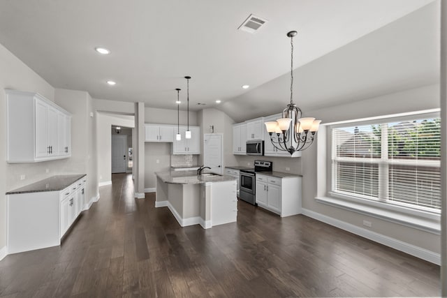 6001 Harwich Ln, Fort Worth, TX 76179 - kitchen featuring appliances with stainless steel finishes, a chandelier, recessed lighting, white cabinetry, and dark stone counters