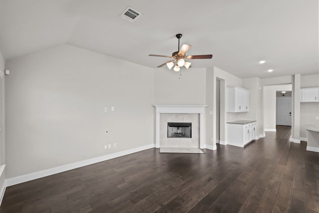 6001 Harwich Ln, Fort Worth, TX 76179 - unfurnished living room featuring ceiling fan, a tile fireplace, dark wood-type flooring, recessed lighting, and vaulted ceiling