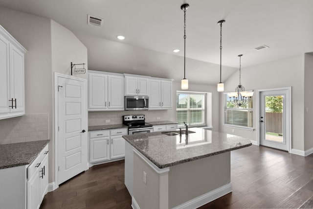 6001 Harwich Ln, Fort Worth, TX 76179 - kitchen with appliances with stainless steel finishes, a chandelier, dark wood-style flooring, lofted ceiling, and white cabinets