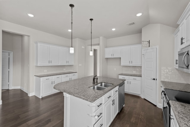 6001 Harwich Ln, Fort Worth, TX 76179 - kitchen featuring appliances with stainless steel finishes, dark wood-style floors, light stone countertops, white cabinetry, and tasteful backsplash