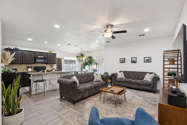 100 Tall Meadow St, Azle, TX 76020 - living area with a ceiling fan, recessed lighting, light wood finished floors, and a chandelier