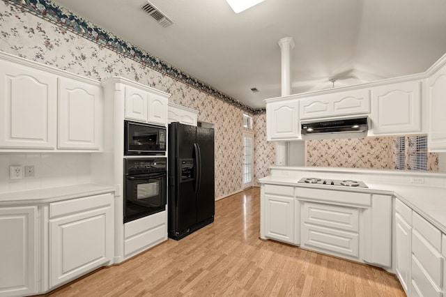 6700 Crane Rd, North Richland Hills, TX 76182 - kitchen featuring black appliances, wallpapered walls, under cabinet range hood, white cabinets, and light countertops