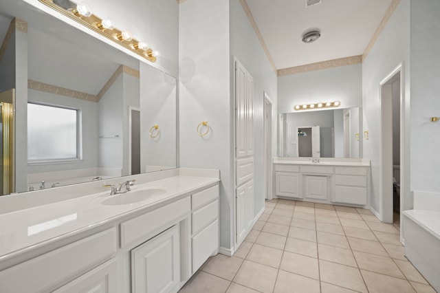 6700 Crane Rd, North Richland Hills, TX 76182 - full bath featuring tile patterned flooring, two vanities, and a tub
