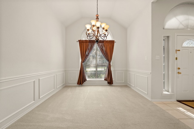6700 Crane Rd, North Richland Hills, TX 76182 - foyer featuring a chandelier, wainscoting, a decorative wall, lofted ceiling, and light tile patterned floors