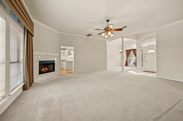6700 Crane Rd, North Richland Hills, TX 76182 - unfurnished living room featuring a tiled fireplace, ornamental molding, ceiling fan, and carpet floors