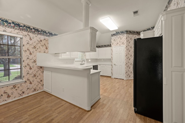6700 Crane Rd, North Richland Hills, TX 76182 - kitchen featuring black appliances, wallpapered walls, a peninsula, light wood-style floors, and plenty of natural light