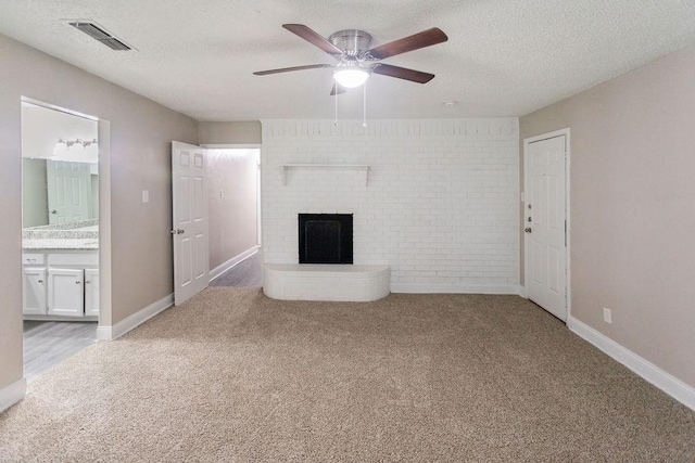 6708 Fair Meadows Dr, North Richland Hills, TX 76182 - unfurnished living room with carpet flooring, a fireplace, a ceiling fan, a textured ceiling, and brick wall