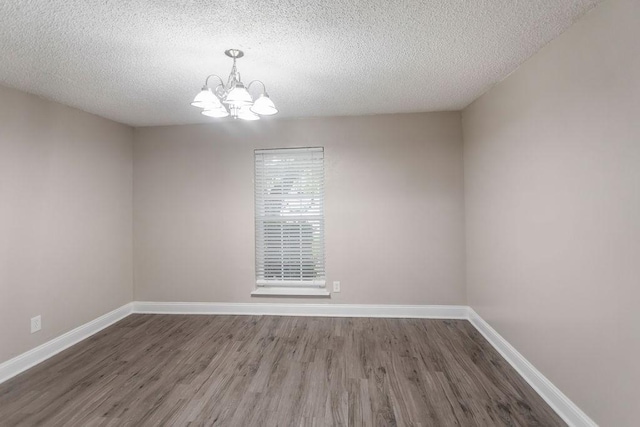 6708 Fair Meadows Dr, North Richland Hills, TX 76182 - spare room featuring a chandelier, wood finished floors, and a textured ceiling