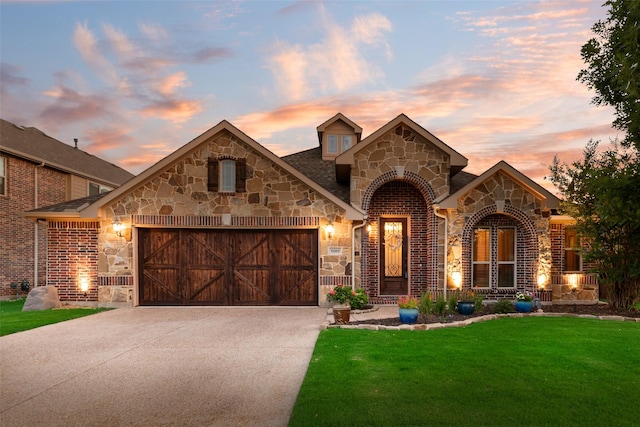 5005 Parkplace Dr, Denton, TX 76226 - french country style house featuring stone siding, a garage, a yard, and concrete driveway