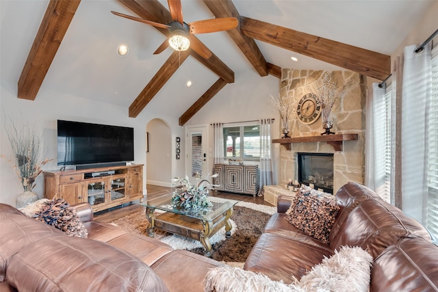5005 Parkplace Dr, Denton, TX 76226 - living room featuring beam ceiling, arched walkways, wood finished floors, ceiling fan, and high vaulted ceiling