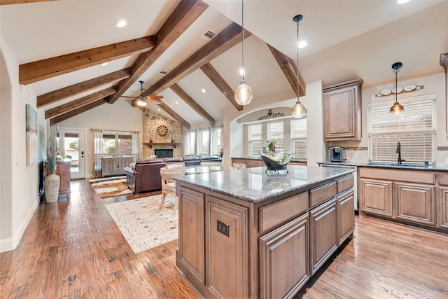 5005 Parkplace Dr, Denton, TX 76226 - kitchen with a stone fireplace, ceiling fan, plenty of natural light, light wood finished floors, and recessed lighting