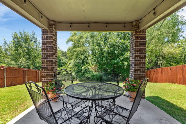1104 Cheyenne Dr, Aubrey, TX 76227 - fenced backyard featuring a patio area, outdoor dining area, and view of wooded area