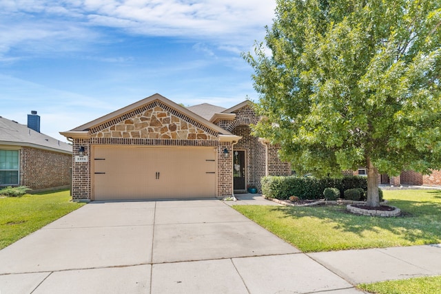 1104 Cheyenne Dr, Aubrey, TX 76227 - view of front of house with brick siding, a front lawn, an attached garage, and concrete driveway