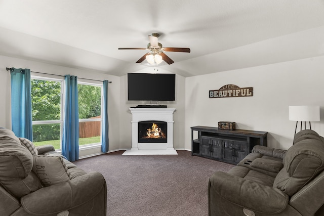1104 Cheyenne Dr, Aubrey, TX 76227 - living room with ceiling fan, dark colored carpet, vaulted ceiling, and a warm lit fireplace