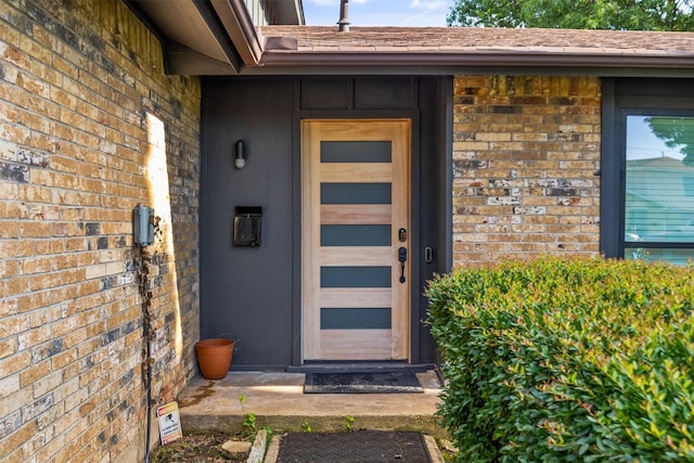 2304 Spanish Trl, Irving, TX 75060 - property entrance featuring brick siding and a shingled roof