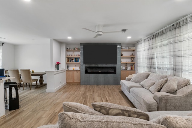 2304 Spanish Trl, Irving, TX 75060 - living area with light wood finished floors, a large fireplace, ceiling fan, and recessed lighting