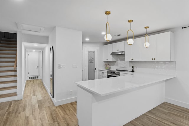 2304 Spanish Trl, Irving, TX 75060 - kitchen featuring light countertops, white cabinets, light wood-style floors, stainless steel electric range, and recessed lighting