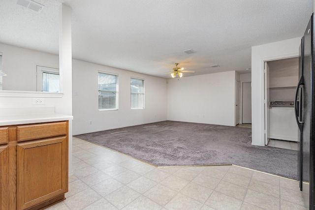 1428 Nimitz Way, Mesquite, TX 75181 - unfurnished living room featuring light carpet, ceiling fan, washer / clothes dryer, and a textured ceiling