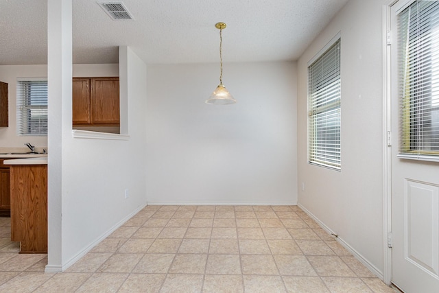 1428 Nimitz Way, Mesquite, TX 75181 - unfurnished dining area with a textured ceiling