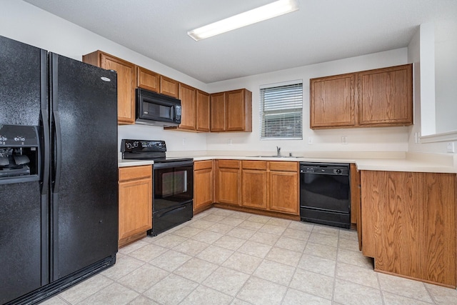1428 Nimitz Way, Mesquite, TX 75181 - kitchen with black appliances, brown cabinetry, light countertops, and light flooring