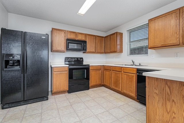 1428 Nimitz Way, Mesquite, TX 75181 - kitchen with black appliances, brown cabinetry, light countertops, and light flooring