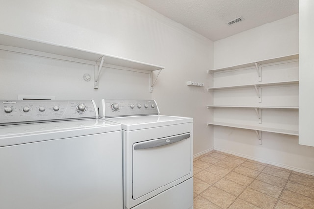 1428 Nimitz Way, Mesquite, TX 75181 - washroom with washing machine and dryer and a textured ceiling