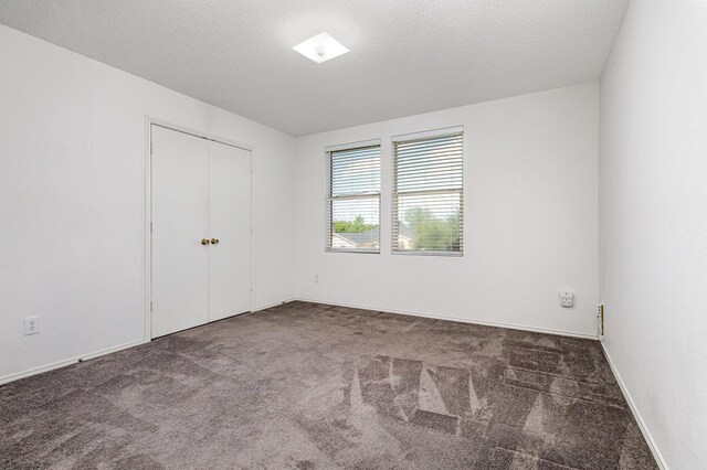 1428 Nimitz Way, Mesquite, TX 75181 - unfurnished bedroom featuring carpet, a textured ceiling, and a closet