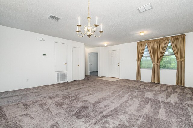 1428 Nimitz Way, Mesquite, TX 75181 - unfurnished living room featuring a chandelier, carpet flooring, and a textured ceiling