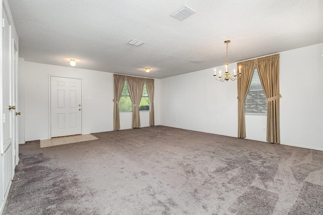 1428 Nimitz Way, Mesquite, TX 75181 - carpeted empty room with a chandelier and a textured ceiling
