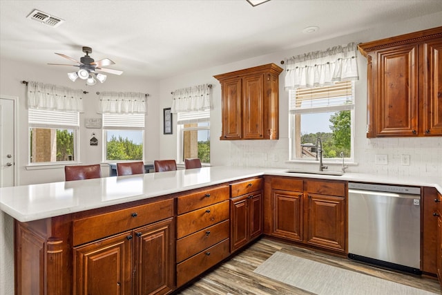 2030 Hills Ct, Stephenville, TX 76401 - kitchen with dishwasher, a peninsula, healthy amount of natural light, and light countertops