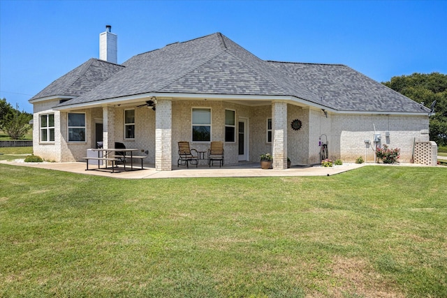 2030 Hills Ct, Stephenville, TX 76401 - back of property featuring a shingled roof, brick siding, a chimney, and a lawn