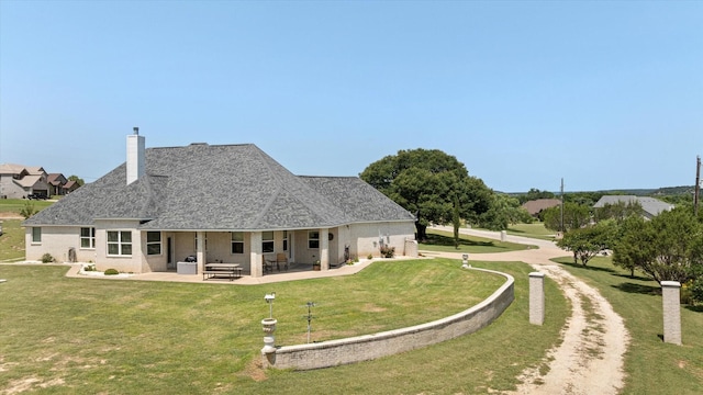 2030 Hills Ct, Stephenville, TX 76401 - rear view of house with a yard, a patio area, a chimney, and a shingled roof