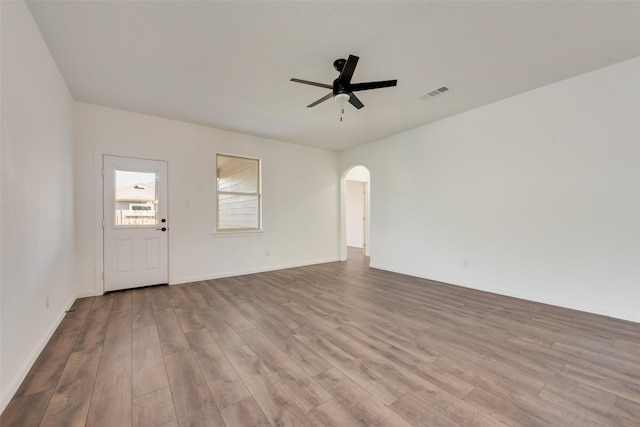 13625 Musselshell Dr, Ponder, TX 76259 - unfurnished living room featuring a ceiling fan, wood finished floors, and arched walkways