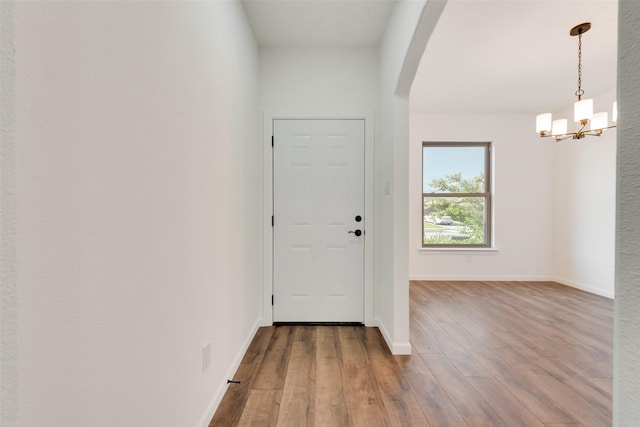 13625 Musselshell Dr, Ponder, TX 76259 - foyer with wood finished floors, arched walkways, and a chandelier