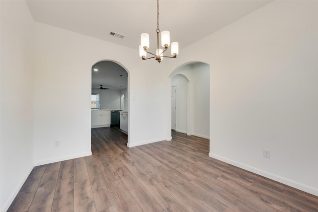 13625 Musselshell Dr, Ponder, TX 76259 - spare room with arched walkways, wood finished floors, and a chandelier