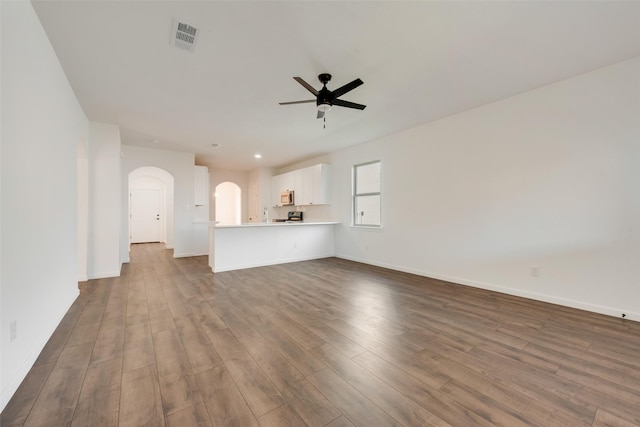 13625 Musselshell Dr, Ponder, TX 76259 - unfurnished living room with ceiling fan, arched walkways, and dark wood finished floors