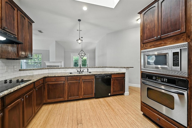 4917 Summer Oaks Ln, Fort Worth, TX 76123 - kitchen featuring black appliances, under cabinet range hood, light wood-style floors, tasteful backsplash, and light stone countertops