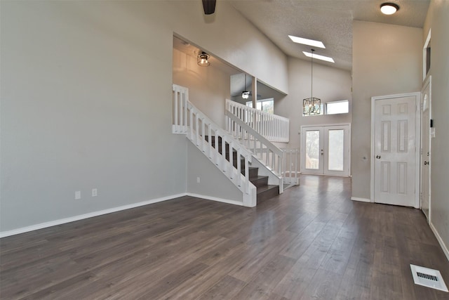 4300 Hidden Creek Dr, Arlington, TX 76016 - entryway with stairs, dark wood finished floors, a textured ceiling, high vaulted ceiling, and a skylight