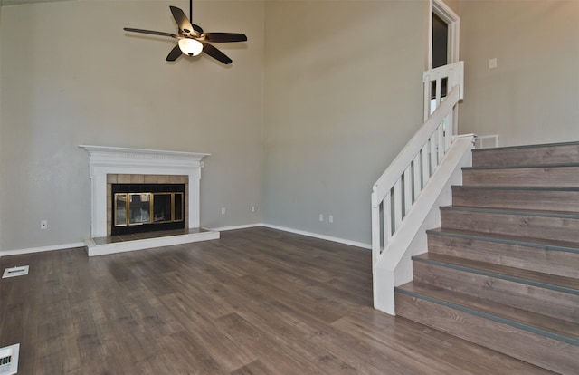 4300 Hidden Creek Dr, Arlington, TX 76016 - unfurnished living room with a ceiling fan, wood finished floors, stairs, a fireplace, and a towering ceiling