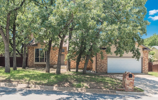 4300 Hidden Creek Dr, Arlington, TX 76016 - obstructed view of property with concrete driveway, brick siding, and a garage