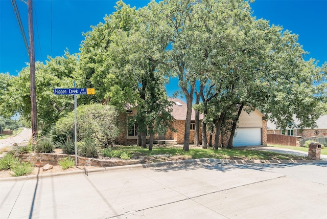 4300 Hidden Creek Dr, Arlington, TX 76016 - obstructed view of property featuring brick siding and concrete driveway