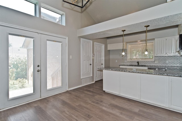 4300 Hidden Creek Dr, Arlington, TX 76016 - kitchen featuring dark stone countertops, french doors, backsplash, white cabinetry, and dark wood-type flooring