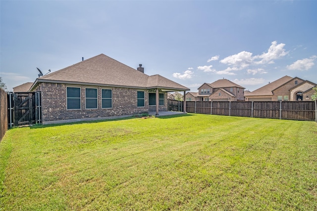 1304 Meridian Dr, Forney, TX 75126 - rear view of house featuring a fenced backyard, a patio, brick siding, roof with shingles, and a chimney