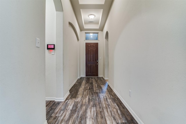 1304 Meridian Dr, Forney, TX 75126 - doorway with arched walkways, dark wood-type flooring, and a raised ceiling