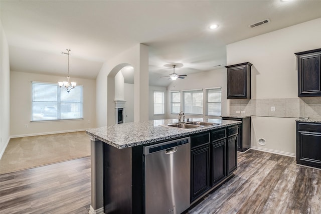 1304 Meridian Dr, Forney, TX 75126 - kitchen featuring dishwasher, a ceiling fan, wood finished floors, open floor plan, and light stone counters