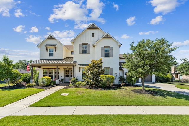 4705 Clydesdale Dr, Flower Mound, TX 75028 - view of front of property featuring a standing seam roof, covered porch, a front yard, concrete driveway, and a metal roof