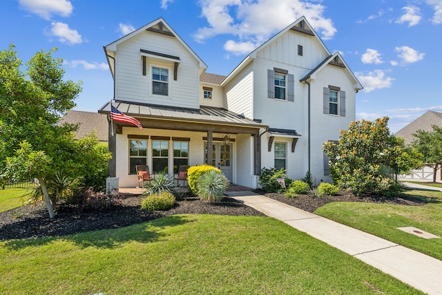4705 Clydesdale Dr, Flower Mound, TX 75028 - view of front facade with a porch, brick siding, a standing seam roof, and a front yard