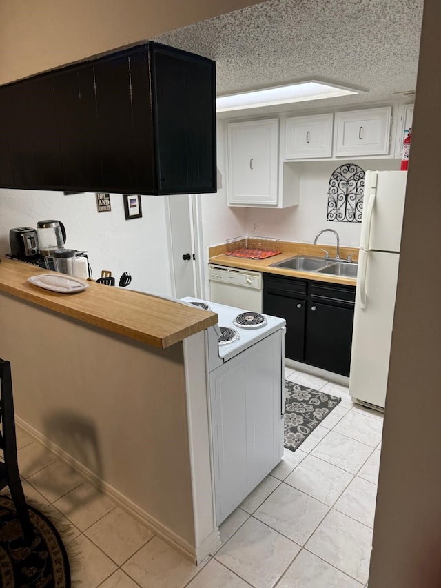 5611 Harvest Hill Rd Unit 1012, Dallas, TX 75230 - kitchen featuring white appliances, dark cabinets, light tile patterned floors, butcher block countertops, and white cabinetry