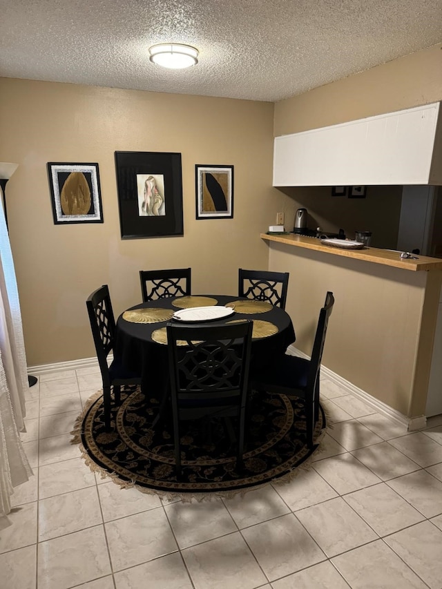 5611 Harvest Hill Rd Unit 1012, Dallas, TX 75230 - dining space with a textured ceiling and light tile patterned floors