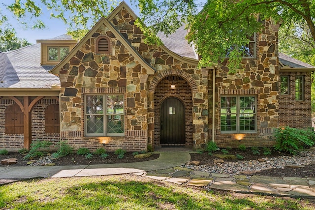 105 Blue Sage Ct, Weatherford, TX 76087 - tudor house featuring a shingled roof and stone siding